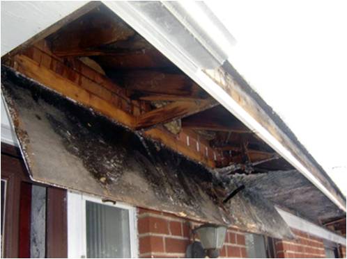 Water damaged soffit caused by a gutter leak.